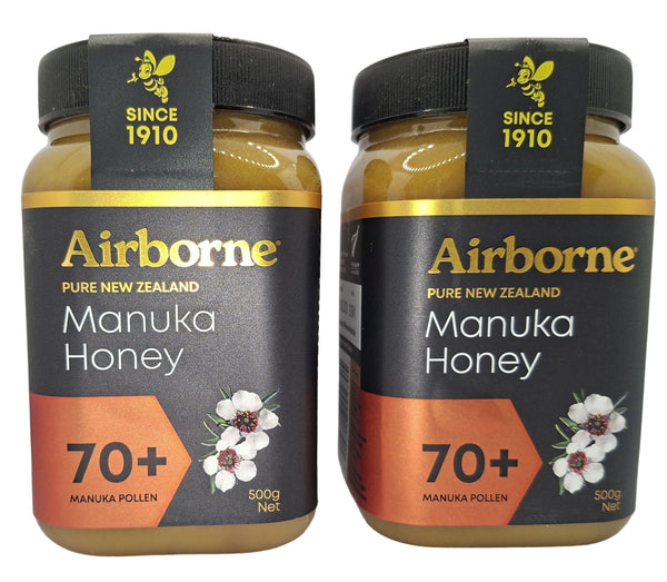 Two jars of Airborne Pure New Zealand Manuka Honey on a white background